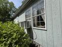 Exterior home detail with a large window and small air conditioning unit at 6722 Heardsville Rd, Cumming, GA 30028