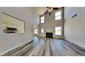 Spacious living room features soaring ceilings, a cozy fireplace, and stylish flooring throughout at 5136 Estonian Dr, Fairburn, GA 30213