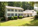 Charming two-story home with blue shutters, freshly mowed lawn, and mature landscaping at 5322 Seaton Dr, Atlanta, GA 30338