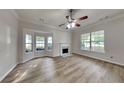 Inviting living room with a cozy fireplace, lots of natural light, and new light wood floors at 700 Patriots Point St, Locust Grove, GA 30248