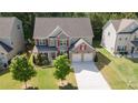 Charming two-story home featuring a well-manicured lawn, attached two car garage, and brick accents at 126 Oakleigh Pointe Dr, Dallas, GA 30157