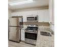 A modern kitchen includes stainless steel appliances, white cabinets, and granite countertops at 3084 Fern Valley Sw Dr, Marietta, GA 30008