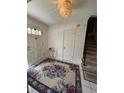 Inviting foyer featuring a decorative rug, chandelier, and staircase to the upper level at 3662 Greentree Farms Dr, Decatur, GA 30034