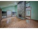 Spacious living room with unique stone fireplace and parquet floors at 3835 Shawnee Sw Run, Lilburn, GA 30047