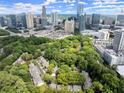 Stunning aerial view of townhomes nestled among lush greenery, with the city skyline as a backdrop at 40 Ivy Chase Ne, Atlanta, GA 30342