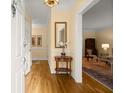 Inviting foyer with gleaming hardwood floors, cream-colored walls, and elegant lighting fixture at 40 Ivy Chase Ne, Atlanta, GA 30342
