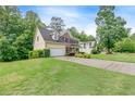 Exterior view of the home highlighting the front yard, driveway, and well-maintained landscaping at 1265 Kelly Nelson Dr, Lawrenceville, GA 30043