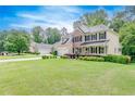 Two story home featuring a well-manicured lawn, driveway, and traditional architectural details at 1265 Kelly Nelson Dr, Lawrenceville, GA 30043