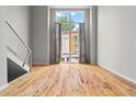 Inviting living area with gleaming hardwood floors and a large window offering natural light at 1271 Ponti Nw Mews # 92, Atlanta, GA 30318