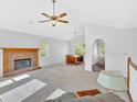 Spacious living room featuring vaulted ceilings, a fireplace, and large windows for ample natural light at 4807 Willowwood Ne Dr, Kennesaw, GA 30144