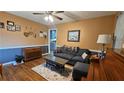 Comfortable living room with wainscotting, hardwood floors, and a stylish rug at 112 Hilltop Dr, Newborn, GA 30056