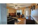 Inviting living room with hardwood floors, a comfortable sofa, and a classic piano at 112 Hilltop Dr, Newborn, GA 30056