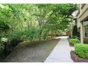 A view of the green and leafy backyard showing the walking path and iron fence at 116 Festoon Ct, Smyrna, GA 30080