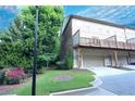 Exterior view of home with attached garage, deck, and lush green landscaping at 116 Festoon Ct, Smyrna, GA 30080
