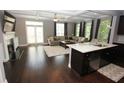 Spacious living room featuring a fireplace, hardwood floors, and a central island at 116 Festoon Ct, Smyrna, GA 30080