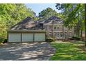 Beautiful brick home with a three-car garage and a well-manicured lawn and landscape at 181 Sentinel Pl, Marietta, GA 30067