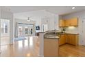 Open-concept kitchen flows seamlessly into the living area with a breakfast bar and modern lighting at 390 17Th Nw St # 6036, Atlanta, GA 30363