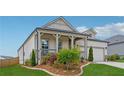 Charming single-Gathering home with a manicured lawn, covered porch, and a lovely garden at 1061 Towne Mill Xing, Canton, GA 30114