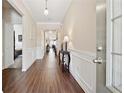 Inviting home hallway with hardwood floors, elegant trim, and access to the bedrooms at 1061 Towne Mill Xing, Canton, GA 30114