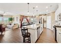 A gourmet kitchen with stainless steel appliances, a granite island, and a breakfast bar at 1061 Towne Mill Xing, Canton, GA 30114