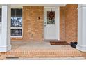 Close-up of the brick facade and front door decorated with a festive wreath at 1646 Highway 92 N, Fayetteville, GA 30214