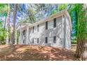 An angled shot of a gray brick home with black shutters and a well-maintained yard at 2922 Carriage Ln, Atlanta, GA 30349