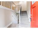 Entryway featuring an updated staircase with iron balusters and a stylish, bright red front door at 2922 Carriage Ln, Atlanta, GA 30349