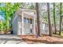 Gray brick home with prominent white columns, red door, and a well-manicured front lawn at 2922 Carriage Ln, Atlanta, GA 30349