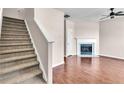 Bright living room featuring a cozy fireplace, and staircase with beautiful hardwood floors at 7120 Oakley Ct, Union City, GA 30291