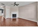 Spacious living room featuring hardwood floors, a fireplace, and a ceiling fan at 7120 Oakley Ct, Union City, GA 30291