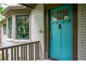 Close-up of a turquoise front door with a decorative knocker and sidelight windows at 138 Garland Ave, Decatur, GA 30030