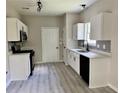 Updated kitchen featuring white cabinets, stainless steel appliances, and modern finishes at 2711 Teal Landing Dr, Morrow, GA 30260