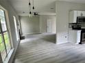 Open-concept living room showcasing hardwood floors, a fireplace, and neutral color palette at 2711 Teal Landing Dr, Morrow, GA 30260