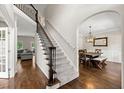 Inviting foyer with hardwood floors, staircase, and an arched entrance to the dining room at 5652 Harbormist Dr, Powder Springs, GA 30127