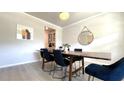 Dining room showing a wooden table with six chairs, hardwood floors and natural light at 1835 Wellston Dr, Lawrenceville, GA 30043