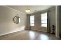 Bright living room featuring hardwood floors, modern lighting, and windows with curtains at 1835 Wellston Dr, Lawrenceville, GA 30043
