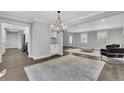 Spacious living room with hardwood floors, modern lighting, and views of the kitchen at 2506 Octavia Ln, Marietta, GA 30062