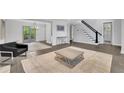 Open-concept living space with hardwood floors, modern lighting, and access to outdoor patio at 2506 Octavia Ln, Marietta, GA 30062