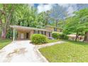 Two-story home boasts mature trees, grass lawn and convenient covered parking at 3900 Bressler Cir, Decatur, GA 30035