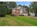 Beautiful two-story brick home with well-maintained lawn and double garage at 4325 Camellia Ridge Sw Way, Lilburn, GA 30047
