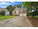 Charming two-story home with brick facade and attached two-car garage at 4325 Camellia Ridge Sw Way, Lilburn, GA 30047