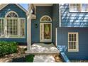 Inviting front entrance with decorative glass door, sidelight window and blue siding at 4915 Bayberry Dr, Cumming, GA 30040