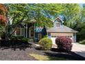 Charming blue two-story home with manicured front yard and inviting walkway at 4915 Bayberry Dr, Cumming, GA 30040