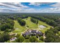 Expansive golf course with scenic fairways, greens, and a clubhouse overlooking a pond at 5065 Harbour Ridge Dr, Alpharetta, GA 30005