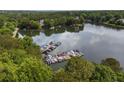 A picturesque lake view showcasing a dock with several boats, surrounded by lush trees at 5065 Harbour Ridge Dr, Alpharetta, GA 30005