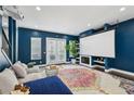 Spacious living room with a large movie screen, comfortable seating, and French doors at 743 Taylor Ne Ct, Atlanta, GA 30324