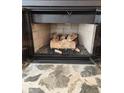 Fireplace with gray stone hearth and gas logs, viewed at close range at 1502 Countryside Se Pl # 1502, Smyrna, GA 30080
