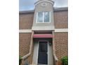 Close up of the entrance showing a black front door with red awning at 3301 Henderson Mill Rd # J1, Atlanta, GA 30341