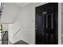Exterior shot of unit J-1 entrance, showcasing the black door and staircase at 3301 Henderson Mill Rd # J1, Atlanta, GA 30341