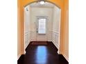 View of the entryway with hardwood floors and white wainscoting and neutral walls at 3981 Isaac Ct, Lilburn, GA 30047